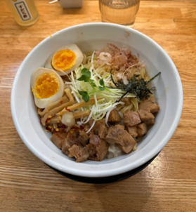 半熟味付け玉子や角切りチャーシュー、メンマ、白髪ネギ、鰹節などが盛り付けられたまぜそば（油そば）
